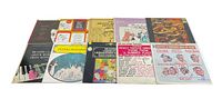Top view showing all 10 vinyl record covers arranged in two rows, colorful covers and text visible.