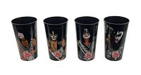 Front views of all four KISS 7 Eleven souvenir cups showing individual band members in colorful makeup and costumes on black plastic.