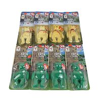 Top-down clear view of four Maple and four Erin Ty Beanie Babies in original McDonald's promotional blister packs arranged in two rows on white background.