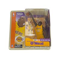 Front of blister pack showing Shaquille O'Neal action figure in Lakers uniform number 34 holding basketball with clear plastic cover, yellowed with age.