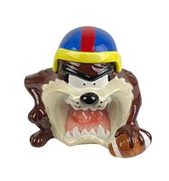 Front view of the Tasmanian Devil cookie jar with open mouth, showing facial details, football helmet and a football in hand.
