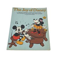 Cover photo showing the title 'The Joy of Disney' with illustrations of Mickey Mouse at a piano and Minnie Mouse sitting on the piano.