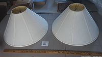 Two large white fabric lamp shades together with ruler for scale, showing overall shape and color