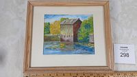Framed watercolor painting of Watson's Mill on river with trees in background.