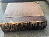 Front cover of the Harper's Magazine volume with brown leather spine and corners, showing wear and some damage to the spine.