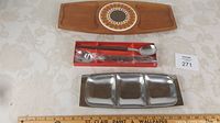 Photo showing all items: teak tray with tile insert, boxed serving spoons, stainless divided tray.