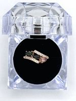 Top view of multi-coloured tourmaline ring inside clear acrylic ring box with black velvet insert.