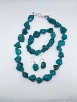 Complete set including necklace, bracelet, and earrings shown laid out flat.