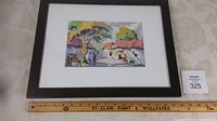 Framed watercolour painting resting on a surface with ruler beneath indicating 14 x 18 inch frame size