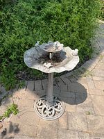 Full view of two tiered metal bird bath with decorative frog figurines and weathered finish.