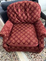 Top front view showing cushioned seat, armrests, and backrest upholstery pattern and condition.