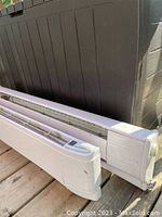Two Dimplex baseboard heaters side-by-side showing digital display on the 40-inch unit and manual knob on 38-inch unit.
