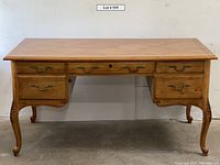 Front view showing top, drawers, handles and leg details