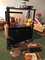 Photo of shelf with marble bookends, owl and duck figurines, a prism, and other assorted items.