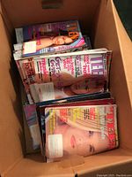 Overhead view of a box filled with multiple Seventeen and Teen magazines stacked inside, showing colorful covers and visible headlines