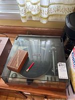 Top view of the Garrard turntable with disc cleaner box and brush on top.