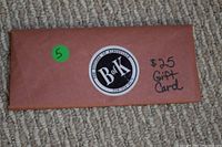 Photo of a brown envelope with a sticker that says Butcher of Kingsville and handwritten text stating $25 Gift Card