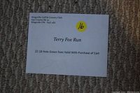 Photo of two paper vouchers for 18 holes of golf each at Kingsville Golf & Country Club, labeled Terry Fox Run, with contact information and conditions.