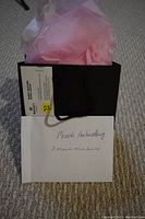 Black gift bag with pink tissue paper, envelope labelled 'Movati Amherstburg 3 month membership' and business card from Movati Amherstburg attached.