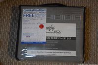 Photo shows packaged bamboo sheet set with visible branding, size, and content information.