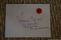 Photo of a handwritten $25 gift certificate from Vernon's Tap & Grill with address and phone number.