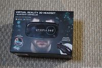 Box showing Utopia 360 Virtual Reality 3D headset and included Bluetooth controller, compatible with smartphones and app stores.