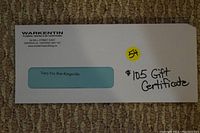 Photo of the envelope containing the $105 gift certificate from Warkentin Plumbing with company address and handwritten note.