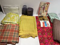 Overview of all fabrics and the vintage sewing pattern envelope arranged on white surface.