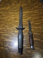 Photo of two vintage cutting knives showing both knives side by side on a wooden surface.