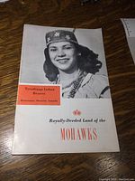 Front cover photo showing smiling woman in traditional Mohawk regalia and booklet title.