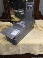 Full side view of vintage Toledo Speedweigh scale showing metal weighing platform and overall condition.