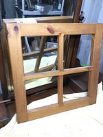 View of the front of the solid pine window frame showing the four window panes and natural wood grain.