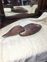 Top and side view of old wooden duck decoy showing the overall shape and repaired areas