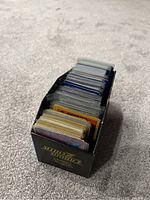 Photo showing a black rectangular deck box filled with Pokémon cards in sleeves and unsleeved.