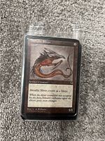 Close up image of a Metallic Sliver artifact creature Magic: The Gathering card showing artwork and card details.