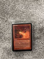 Photo of a Magic: The Gathering red sorcery card 'Firebolt' showing dragon artwork and card details.