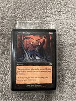 Close-up of a 'Mind Sludge' Magic: The Gathering card showing artwork and game text