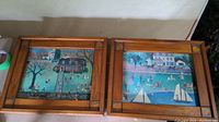Two pine wood framed prints laid side by side showing detailed schoolyard scenes with children playing outside. Frames are natural wood with corner accents.
