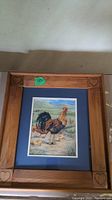 Rooster print framed in pine wood with carved hearts on the corners. Approximate frame size 24 x 22 inches.