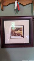 Framed print of "The Drive" by Tom Thomson hanging on a wall with visible keys above it.