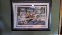 Full view of framed print showing stone bridge scene in winter with snow on ground and stacked wood on bridge.