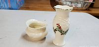 Two Lenox vases, 2-inch and 5-inch, with holiday holly decorative pattern photographed from top and side views