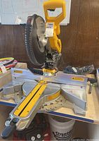 Front and side view of the saw installed on tabletop showing sliding rails, fence and blade guard