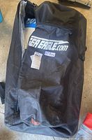 Black SeaEagle.com zippered carry bag with SUP Board label partially unzipped