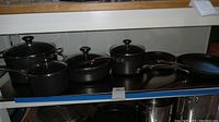 Full overview of cookware set on shelf