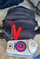 Power inflator with carrying case and battery clamps, front view