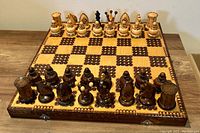 Full chess board with all pieces set for play, showing both light and dark wood sets and patterned board