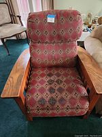 Photo of a mission style recliner chair with wooden arms and patterned fabric upholstery.