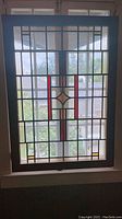 Full view of vintage decorative glass window pane showing overall design, colors, and condition.