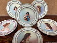 6 Limoges portrait plates displayed showing individual hand-painted female portraits and decorative borders.